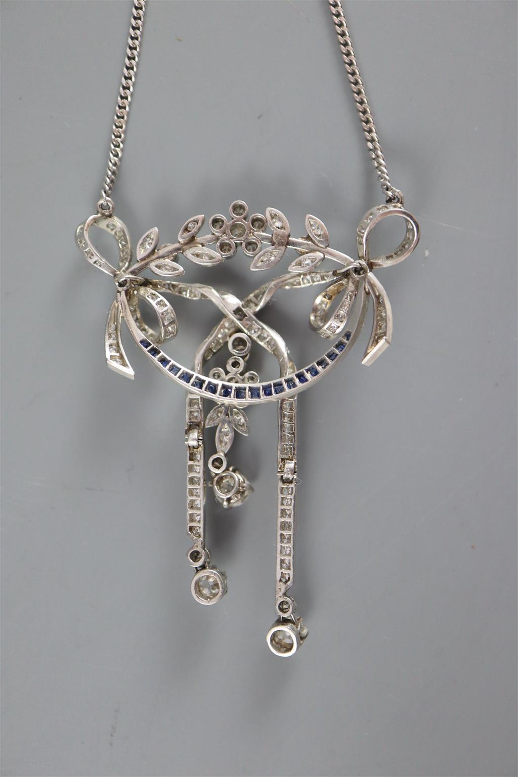 An early 20th century platinum, sapphire and diamond set articulated openwork drop pendant necklace,